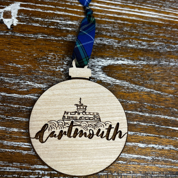 Round wooden ornament with laser engraved design, a line drawn Dartmouth Ferry and script font reading 