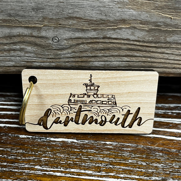 Wooden keychain with gold ring and laser engraved ferry with script font underneath reading 'dartmouth'