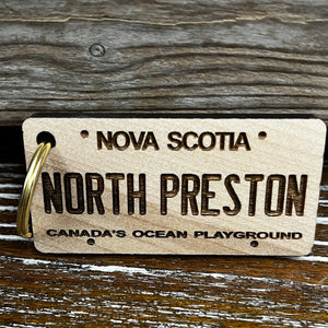 Rectangle wooden keychain with gold key ring, laser engraved with "North Preston" with "Nova Scotia - Canada's Ocean Playground" in a smaller font. 