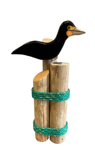 Large Cormorant on wood pilings