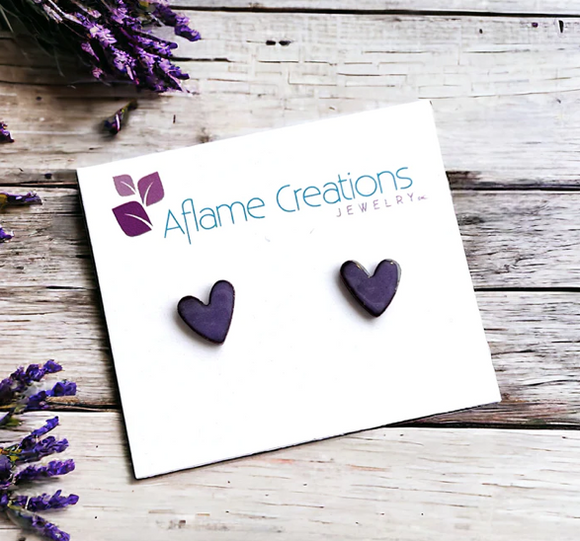 Enamelled copper heart shaped studs in a light lavender colour attached to a branded backing card