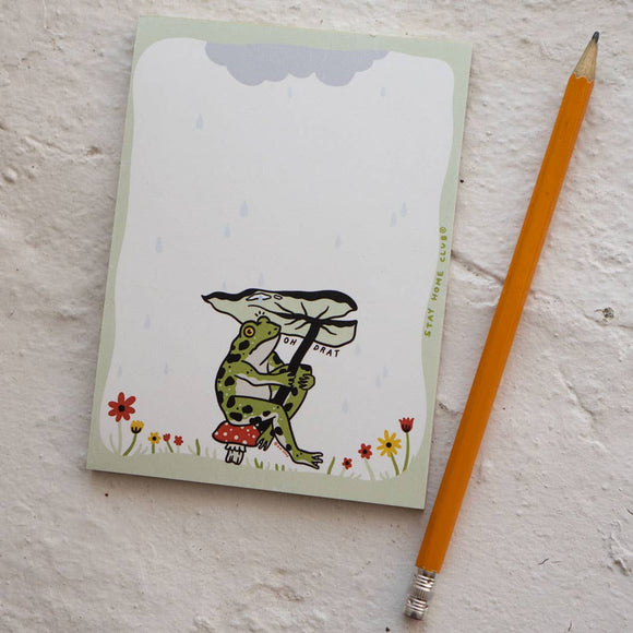 Illustrated frog notepad sitting on a white notepad